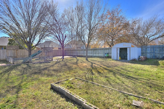 view of yard featuring a playground and a shed