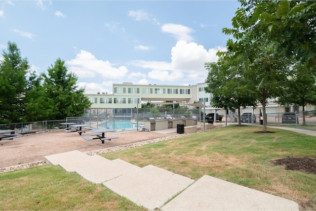 view of property's community featuring a pool and a yard