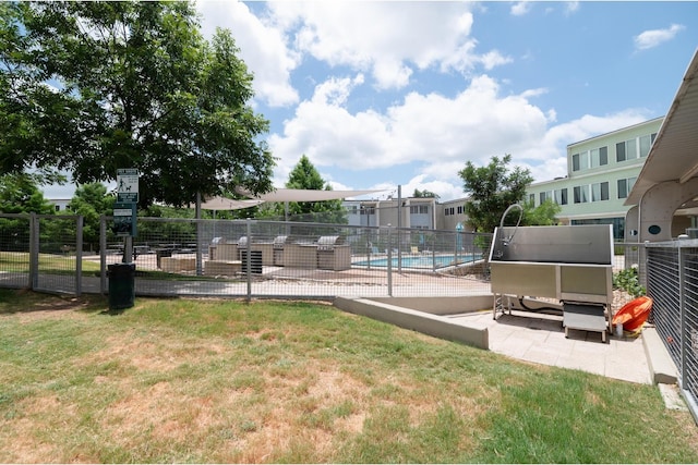 view of swimming pool featuring a yard and a patio