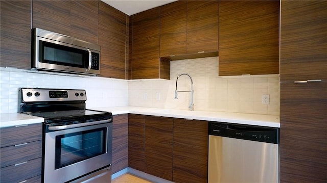 kitchen featuring backsplash, sink, and stainless steel appliances