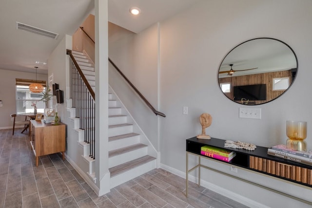 stairs with ceiling fan