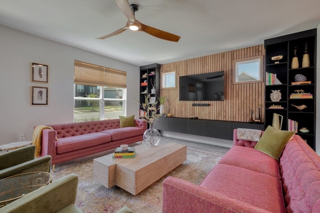 living room with light wood-type flooring and ceiling fan