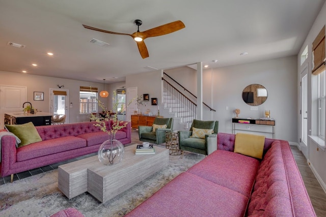 living room featuring ceiling fan and dark hardwood / wood-style floors