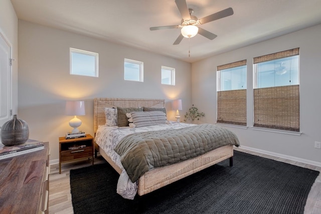 bedroom with light wood-type flooring and ceiling fan