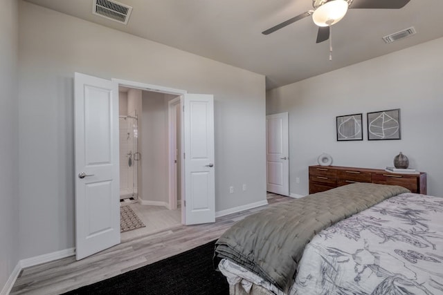 bedroom featuring ceiling fan, light hardwood / wood-style floors, and connected bathroom