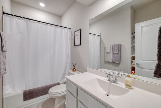 full bathroom featuring toilet, shower / bath combo with shower curtain, and vanity