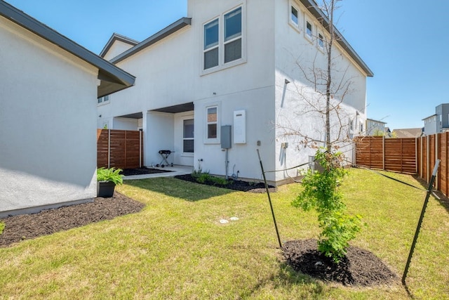 rear view of house with a yard