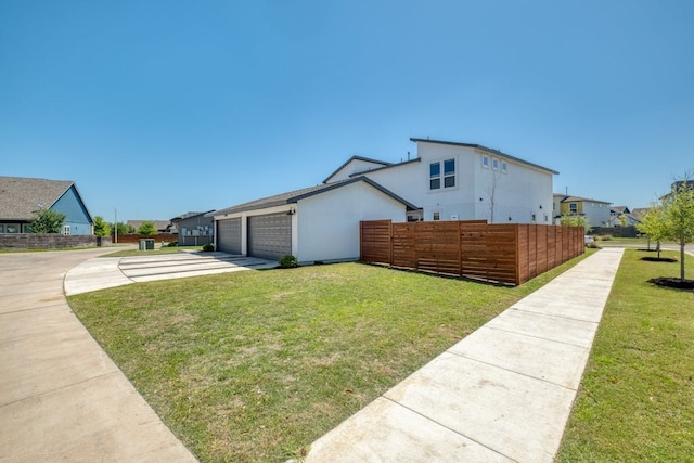 view of home's exterior with a lawn and a garage