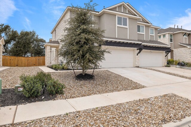 2213 Rocoso Trl, Leander, TX 78641 - multi unit property with stucco siding, an attached garage, concrete driveway, and stone siding