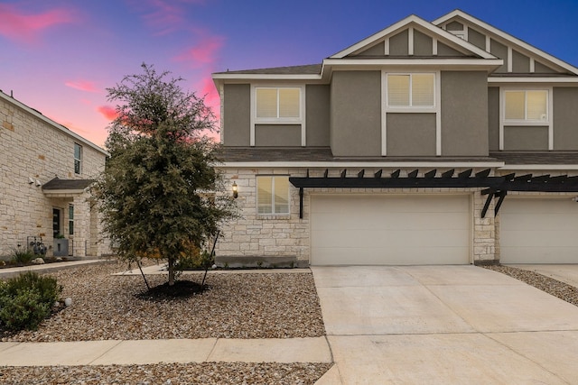 2213 Rocoso Trl, Leander, TX 78641 - townhome / multi-family property with stone siding, a garage, and stucco siding