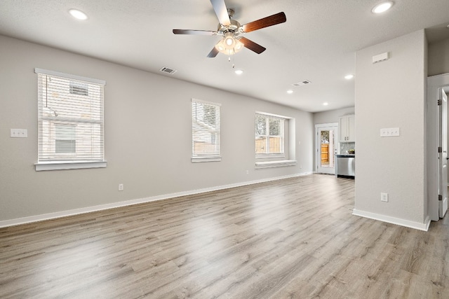 2213 Rocoso Trl, Leander, TX 78641 - unfurnished living room featuring ceiling fan, light wood finished floors, recessed lighting, and baseboards