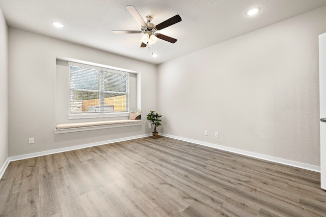 spare room featuring ceiling fan and wood-type flooring