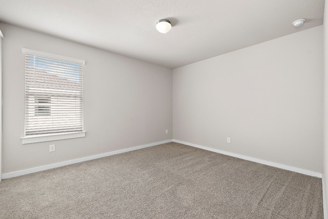 2213 Rocoso Trl, Leander, TX 78641 - empty room featuring carpet floors, baseboards, and a smoke detector