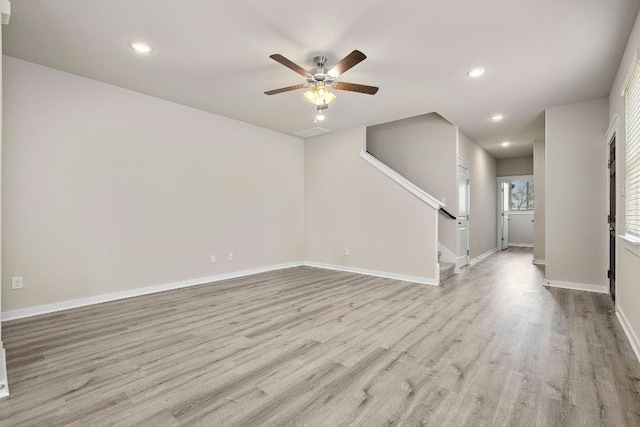 unfurnished living room with ceiling fan and light hardwood / wood-style flooring