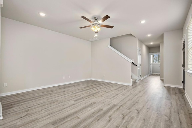 2213 Rocoso Trl, Leander, TX 78641 - unfurnished living room with ceiling fan, stairs, recessed lighting, wood finished floors, and baseboards