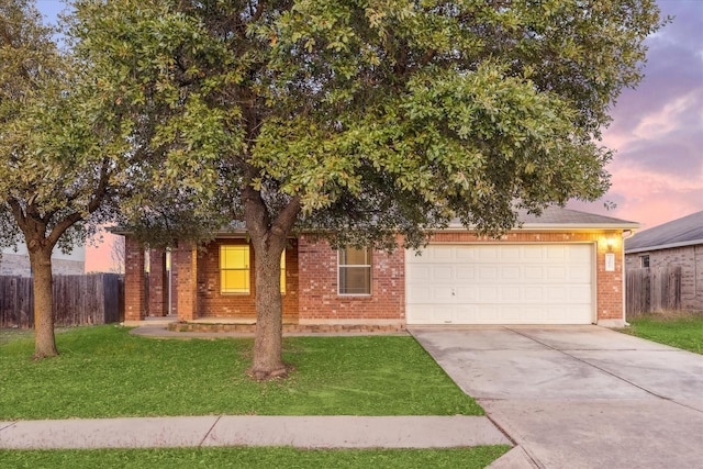 obstructed view of property featuring a yard and a garage