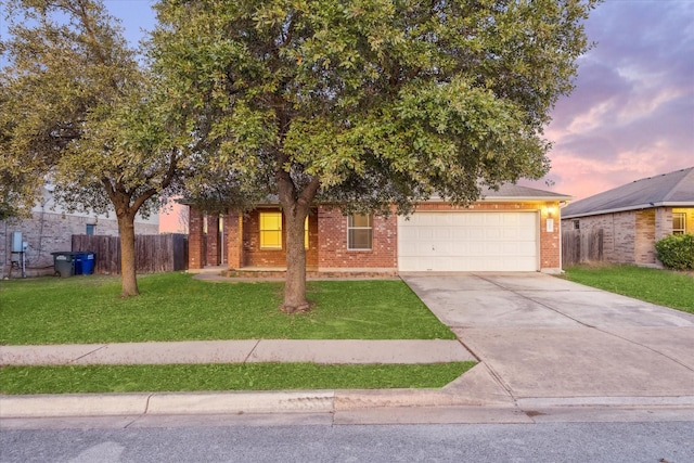 view of property hidden behind natural elements with a lawn and a garage