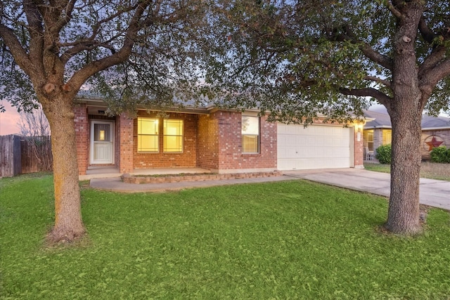 view of front facade with a lawn and a garage