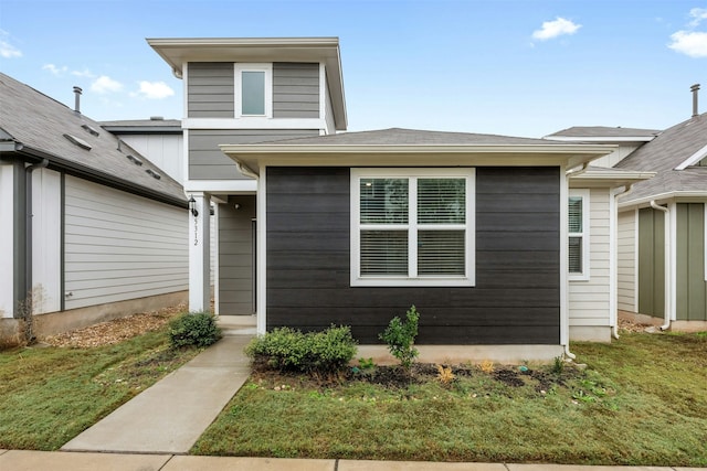 view of exterior entry featuring a yard