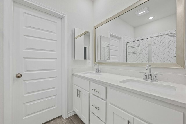 bathroom featuring an enclosed shower and vanity