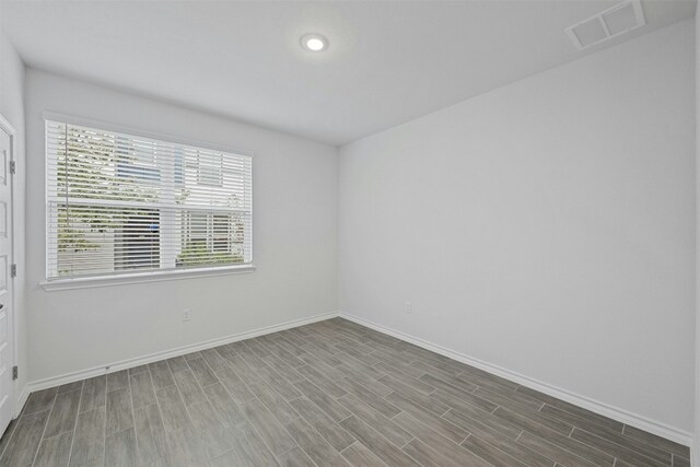 unfurnished room featuring wood-type flooring