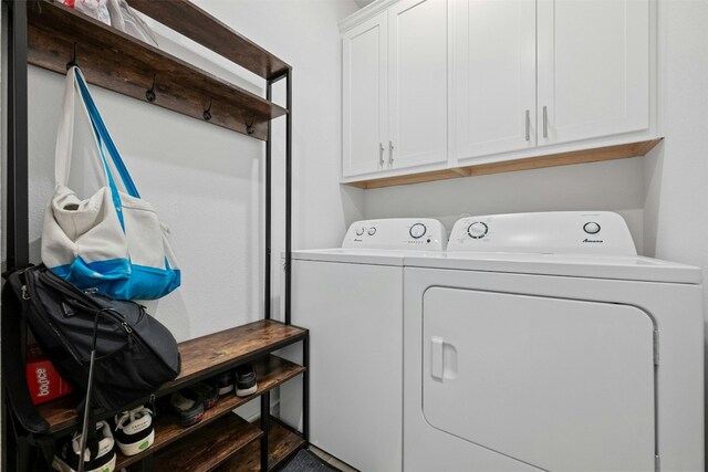 laundry room featuring cabinets and washing machine and dryer