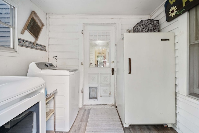 laundry room featuring washer and clothes dryer and dark hardwood / wood-style floors