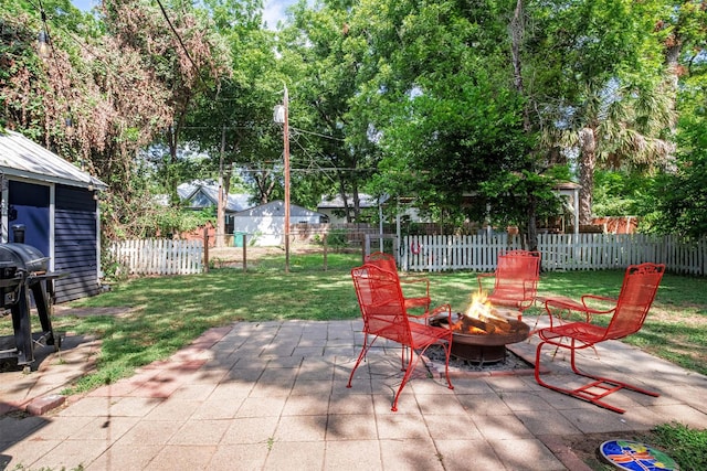 view of patio / terrace with grilling area and a fire pit