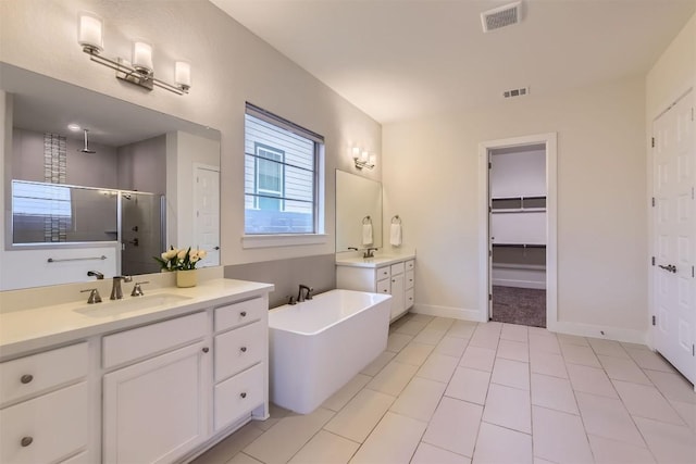 full bath with two vanities, a stall shower, visible vents, and a sink