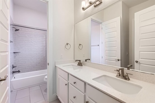 bathroom with double vanity, toilet, a sink,  shower combination, and tile patterned flooring