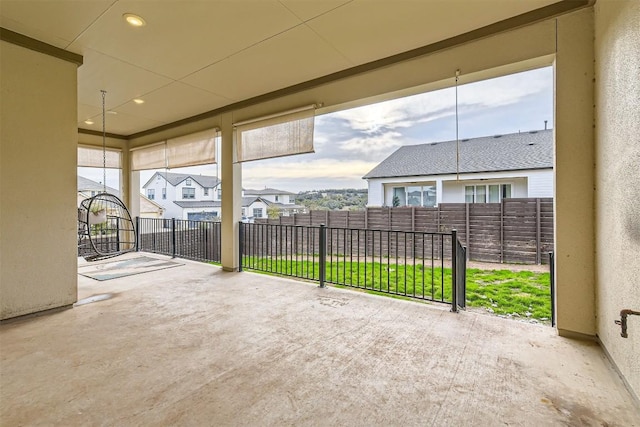 view of patio / terrace with fence and a residential view