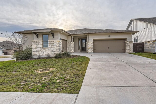 view of front facade with a front yard and a garage