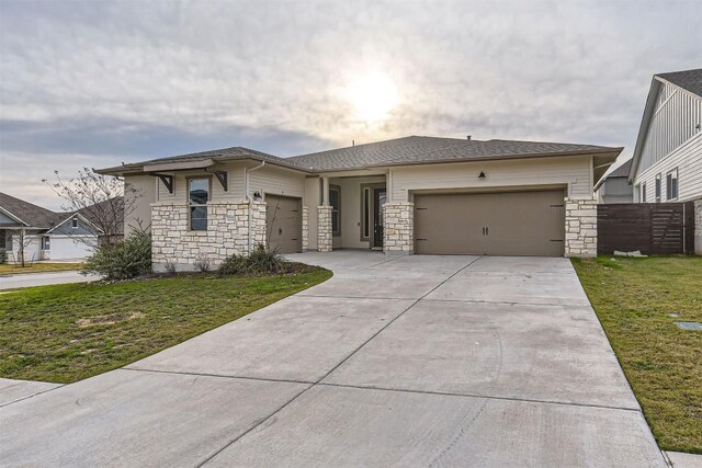 view of front of house with a front yard and a garage