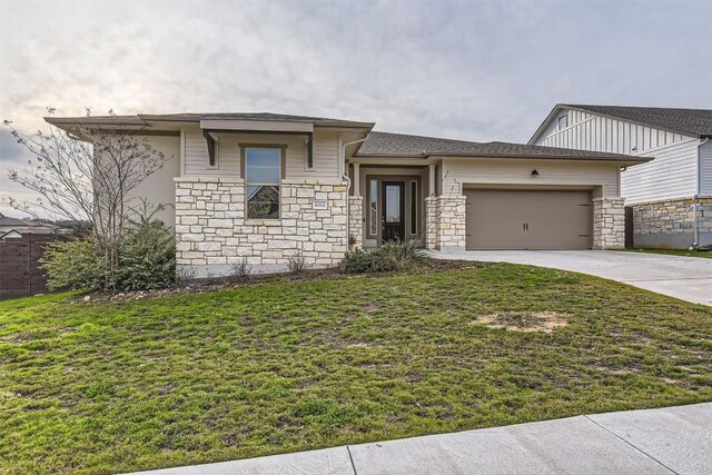 view of front of home featuring a front yard and a garage