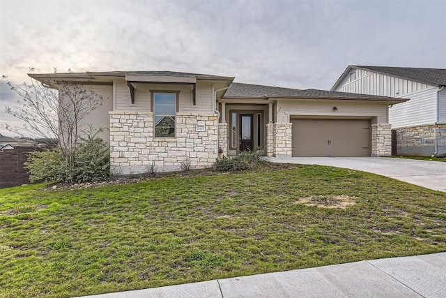 view of front facade with a front yard, stone siding, driveway, and an attached garage