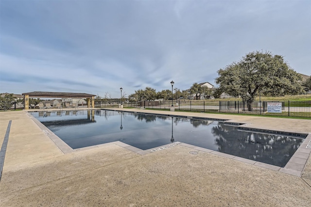 view of swimming pool with a gazebo and a water view