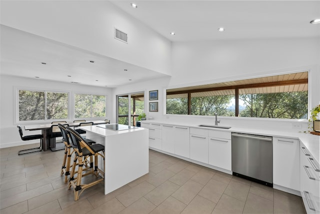 kitchen featuring a kitchen island, white cabinets, dishwasher, and sink