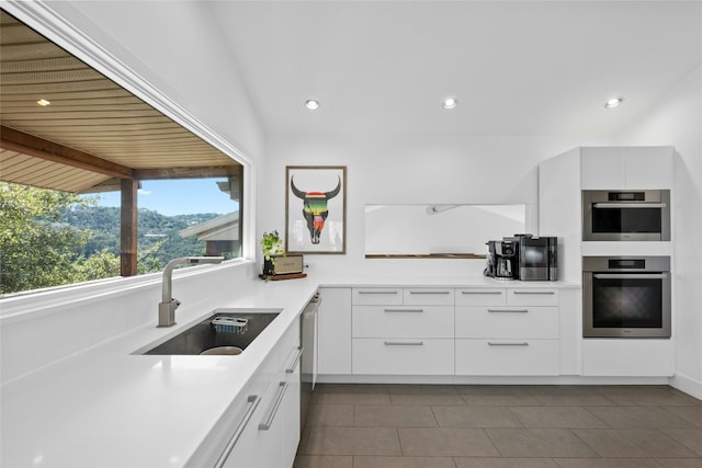 1603 Twilight Ridge Dr, Austin, TX 78746 - kitchen featuring modern cabinets, white cabinets, dark tile patterned flooring, light countertops, and stainless steel dishwasher