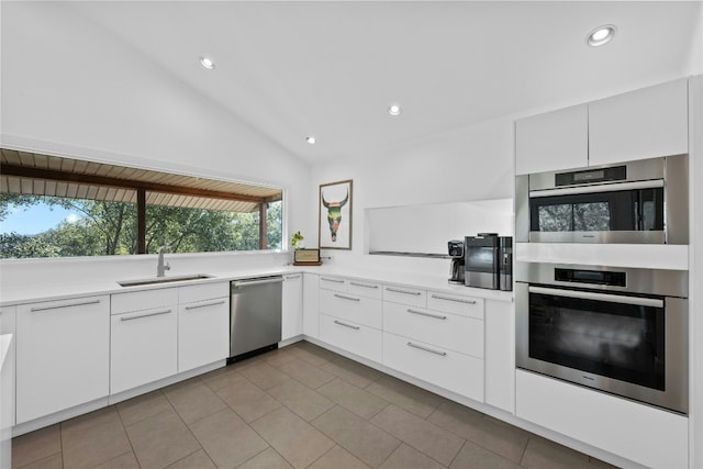 1603 Twilight Ridge Dr, Austin, TX 78746 - kitchen featuring appliances with stainless steel finishes, recessed lighting, light tile patterned flooring, white cabinets, and light countertops