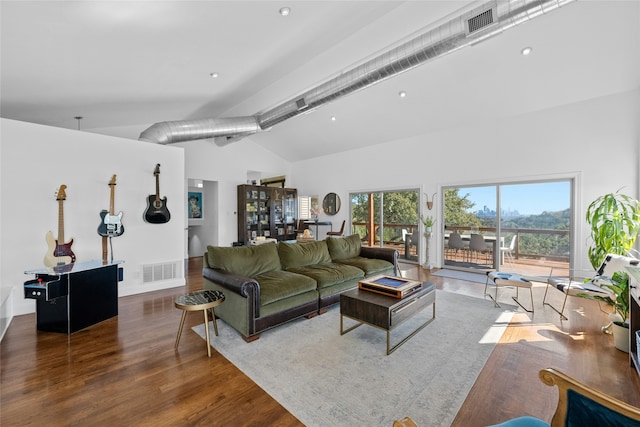 living room featuring high vaulted ceiling and dark hardwood / wood-style floors