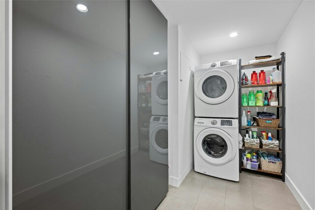 1603 Twilight Ridge Dr, Austin, TX 78746 - washroom featuring stacked washing machine and dryer, light tile patterned floors, and recessed lighting