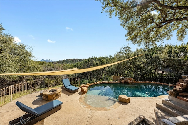 view of swimming pool with a fire pit and a patio