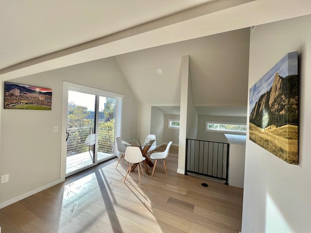 doorway featuring vaulted ceiling and light hardwood / wood-style floors