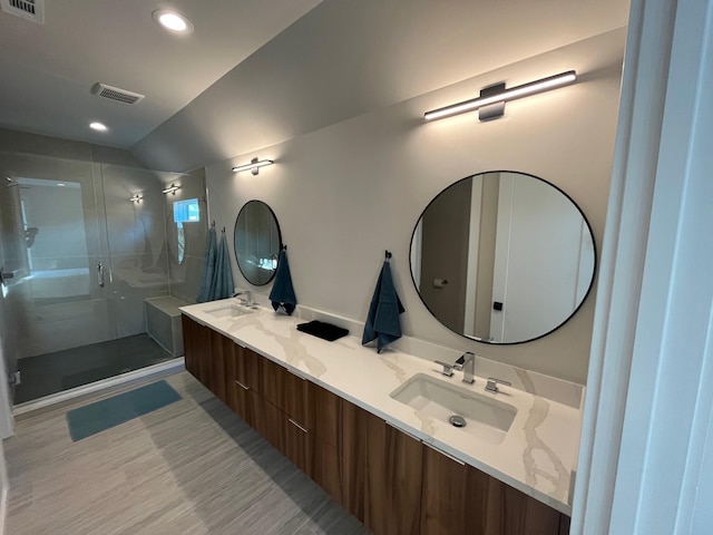 bathroom with vanity and a shower with shower door