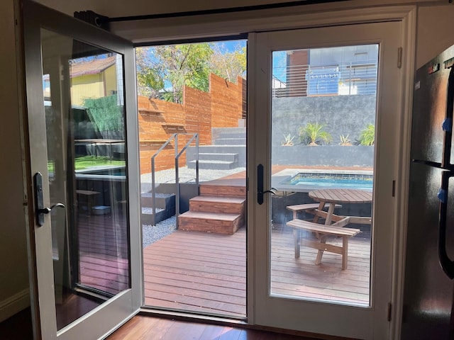 doorway to outside with hardwood / wood-style flooring and plenty of natural light