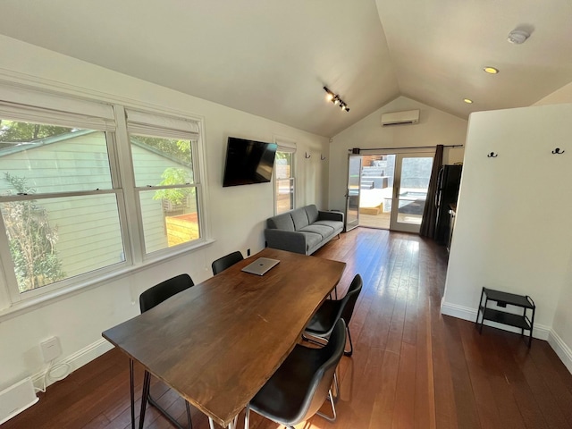 dining space with dark hardwood / wood-style flooring, an AC wall unit, vaulted ceiling, and a wealth of natural light