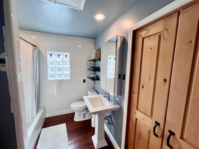 bathroom featuring shower / tub combo, toilet, and hardwood / wood-style flooring