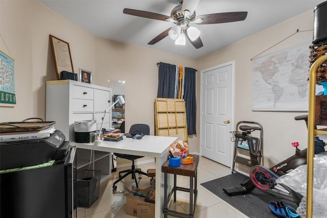 tiled home office featuring ceiling fan