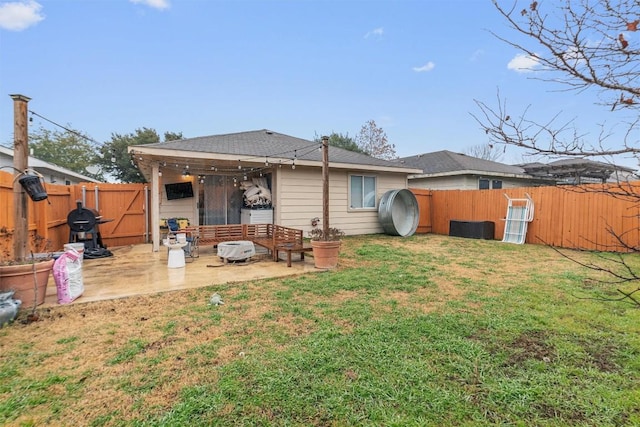 back of house featuring a yard and a patio area