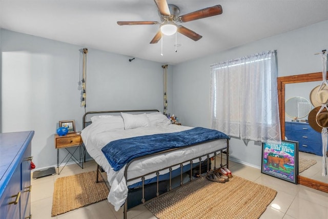 tiled bedroom featuring ceiling fan